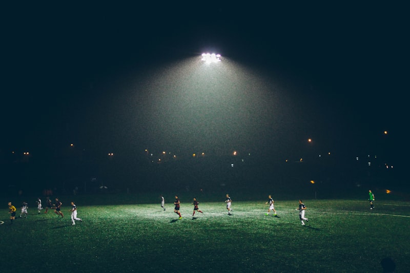 Football players competing under stadium lights